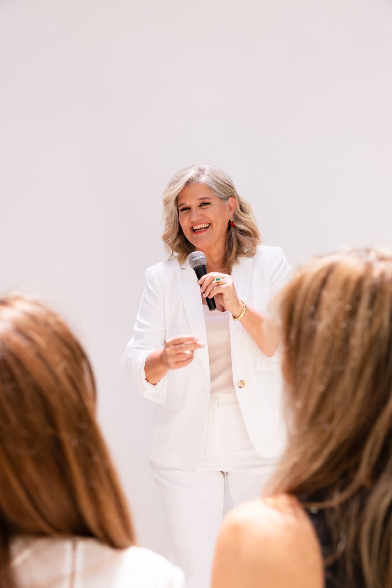 Dolores Hirschmann speaking on stage with a microphone